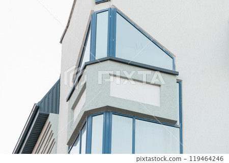 Modern architectural design showcasing a sleek glass corner of a contemporary building Modern architectural design showcasing a sleek glass corner of a contemporary building 119464246