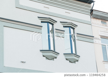 Elegant Vintage Facade with Modern Windows Accentuated by Soft Colors 119464258