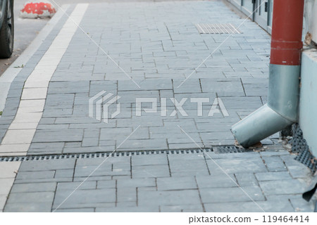 Urban Streetscape with Stone Pavement and Drainage Features Urban Streetscape with Stone Pavement and Drainage Features 119464414