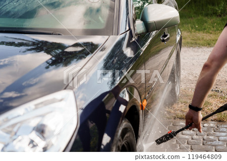 A Brightly Reflective Car Being Thoroughly Hand-Washed on a Sunny Day A Brightly Reflective Car Being Thoroughly Hand-Washed on a Sunny Day 119464809
