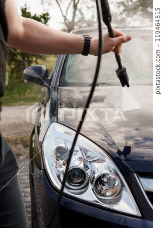 Car Being Hand-Washed with High-Pressure Water Hose on a Sunny Day Car Being Hand-Washed with High-Pressure Water Hose on a Sunny Day 119464815