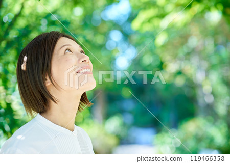 Smiling woman in the greenery on a nice day Smiling woman in the greenery on a nice day 119466358