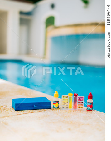 Chlorine and ph tester for swimming pools. Water test kit on the edge of the swimming pool. Chlorine test kit for swimming pools 119466444