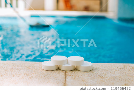 Chlorine tablets for swimming pool cleaning. close up of chlorine tablets on the edge of a swimming pool. 119466452