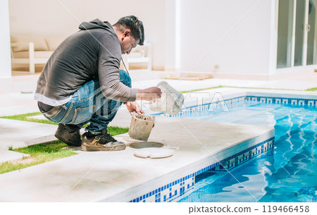 Person cleaning garbage filter basket for swimming pool. Man cleaning swimming pool filter basket Person cleaning garbage filter basket for swimming pool. Man cleaning swimming pool filter basket 119466458