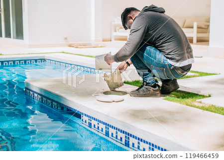 Man cleaning swimming pool garbage filter. Worker removing trash from swimming pool filter basket 119466459