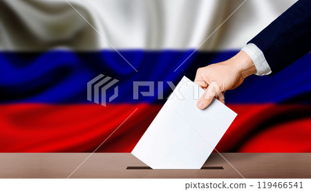 Presidential elections of the Russian Federation. Hand holding ballot in the ballot box with Russia flag in the background 119466541