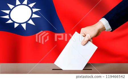 Taiwan presidential election. Hand holding ballot in ballot box with Taiwan flag in background 119466542