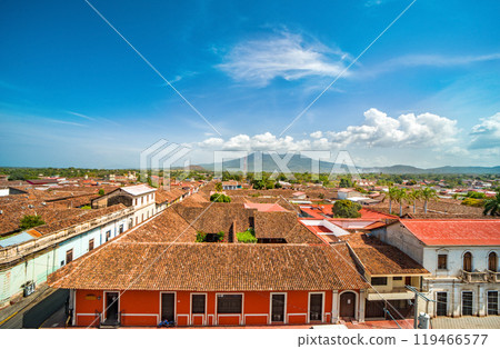 View of the tiled roofs of the colorful buildings in Granada, Nicaragua. Top view of the facade of colorful colonial buildings in the city of Granada 119466577