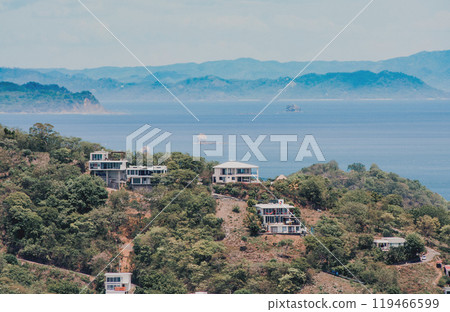 View of houses on top of a hill overlooking the beach, San Juan del Sur. Houses on top of a hill overlooking the ocean View of houses on top of a hill overlooking the beach, San Juan del Sur. Houses on top of a hill overlooking the ocean 119466599
