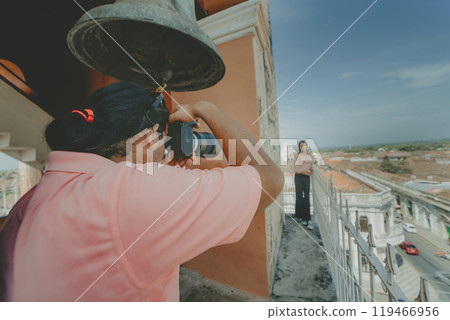 Tourists taking photographs at the viewpoint of the La Merced church, Granada. Tourist couple taking pictures at the viewpoint of the La Merced church 119466956