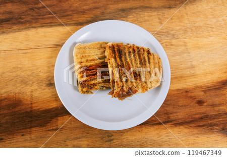 Top view of two meat and chicken panini on wooden table Top view of two meat and chicken panini on wooden table 119467349