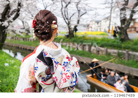 A young woman smiling in a furisode kimono in spring A young woman smiling in a furisode kimono in spring 119467489