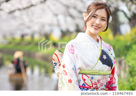 A young woman smiling in a furisode kimono in spring 119467493