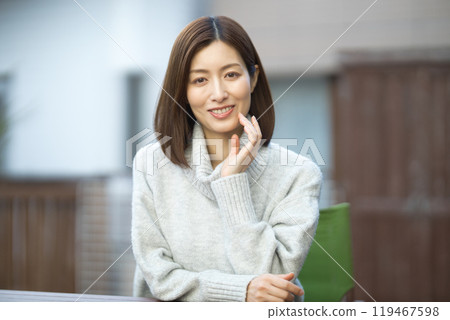 Beauty of a woman in her 40s wearing a sweater 119467598