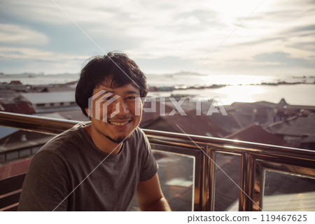 Smile man enjoy the happy moment with sunset and sea view. Smile man enjoy the happy moment with sunset and sea view. 119467625