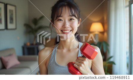 Smiling girl taking selfie with dumbbell, workout at home during pandemic, wearing activewear Smiling girl taking selfie with dumbbell, workout at home during pandemic, wearing activewear 119468911