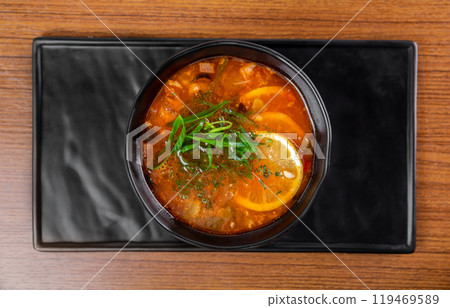 Russian soup Solyanka on wooden table side view Russian soup Solyanka on wooden table side view 119469589