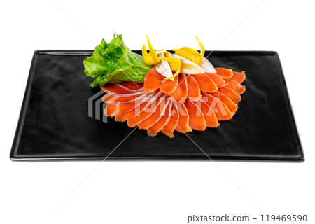 slicing appetizer of red fish slices on a black plate on a white background top view 119469590
