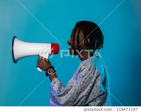 African American man dons traditional attire, passionately utilizing a megaphone against a striking blue background, symbolizing his vocal and cultural empowerment in the pursuit of social justice and African American man dons traditional attire, passionately utilizing a megaphone against a striking blue background, symbolizing his vocal and cultural empowerment in the pursuit of social justice and 119471197