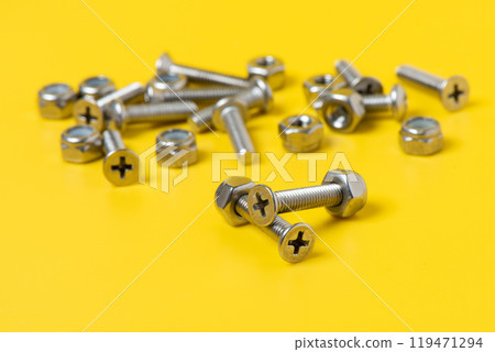 metal screw over yellow background. metal screw over yellow background. 119471294