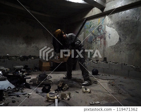 A person destroying trash with an iron pipe A person destroying trash with an iron pipe 119471362