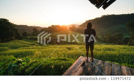Rural rice field tour, man standing taking pictures on the rice field terrace and morning light 119471472