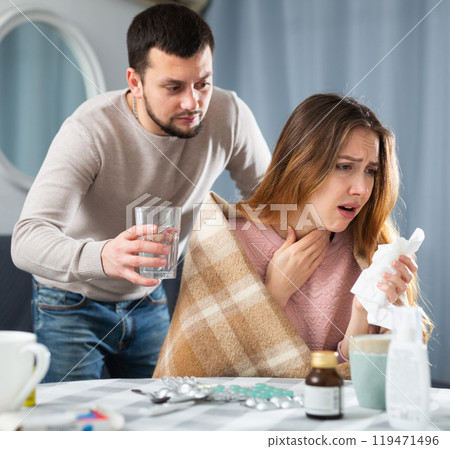 Sick woman resting at home with husband 119471496