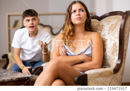 Family quarrel. Couple during conflict in live roome Family quarrel. Couple during conflict in live roome 119471917