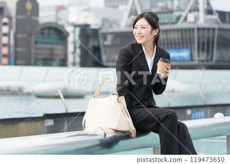 年輕女商人在市中心喝外帶咖啡放鬆 119473650