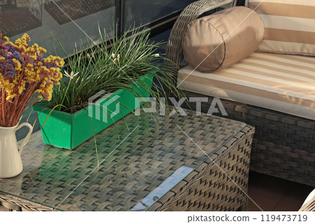 Wicker patio furniture on timber deck in sunny summer day. Garden furniture for relaxing.  119473719