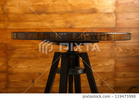 A stylish round table showcasing a stunning petrified wood top 119473998