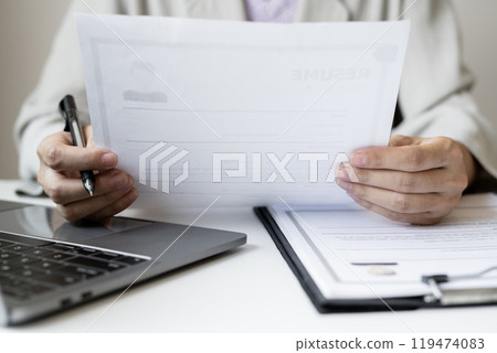Business woman employer holding resume hiring recruit looking cv resume to hire candidates, analyzing information before job interview. Recruitment concepts Business woman employer holding resume hiring recruit looking cv resume to hire candidates, analyzing information before job interview. Recruitment concepts 119474083