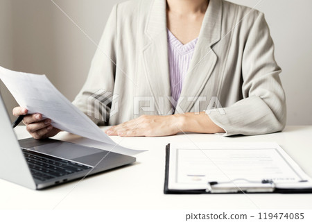 Business woman employer holding resume hiring recruit looking cv resume to hire candidates, analyzing information before job interview. Recruitment concepts Business woman employer holding resume hiring recruit looking cv resume to hire candidates, analyzing information before job interview. Recruitment concepts 119474085