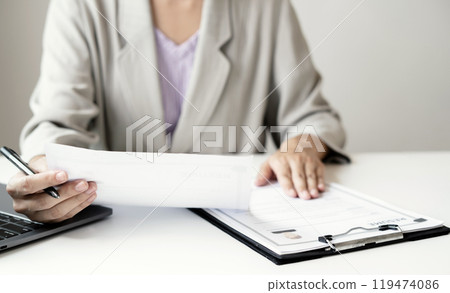 Business woman employer holding resume hiring recruit looking cv resume to hire candidates, analyzing information before job interview. Recruitment concepts Business woman employer holding resume hiring recruit looking cv resume to hire candidates, analyzing information before job interview. Recruitment concepts 119474086