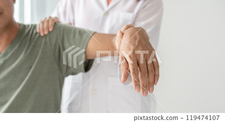Female physiotherapists provide physical assistance to male patients with shoulder injuries massaging their shoulders for muscle recovery in the rehabilitation center. Physiotherapy concepts Female physiotherapists provide physical assistance to male patients with shoulder injuries massaging their shoulders for muscle recovery in the rehabilitation center. Physiotherapy concepts 119474107