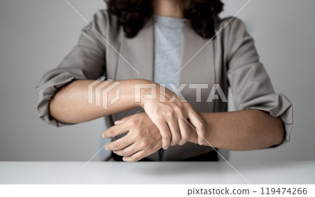 Woman hand with wrist pain numbness and pain in the palm of the hand has pain and tingling in the nerve endings This is a side effect of sitting and working for a long time on a laptop at the office 119474266