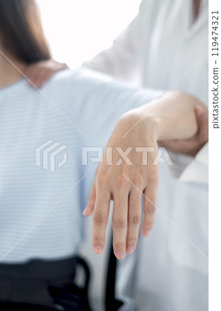 Female physiotherapists provide physical assistance to women patients with elbow injuries examine patients in rehabilitation centers. Physiotherapy concepts 119474321