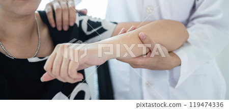 Female physiotherapists provide physical assistance to women patients with elbow injuries examine patients in rehabilitation centers. Physiotherapy concepts 119474336
