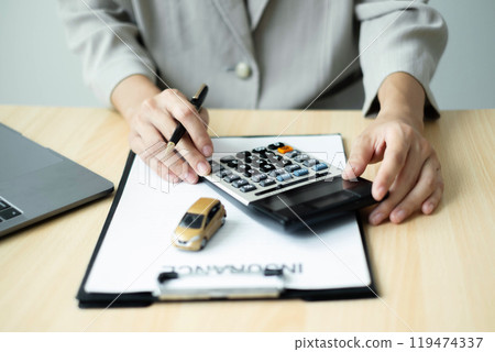 Car dealer businessWoman signing car insurance document or lease paper. Car loan and insurance concept 119474337