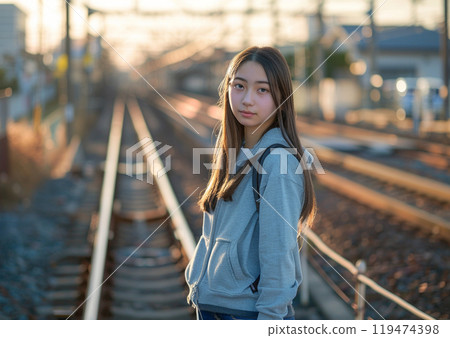 Woman standing on train tracks Woman standing on train tracks 119474398