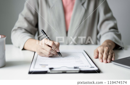 Business woman employer holding resume hiring recruit looking cv resume to hire candidates, analyzing information before job interview. Recruitment concepts Business woman employer holding resume hiring recruit looking cv resume to hire candidates, analyzing information before job interview. Recruitment concepts 119474574