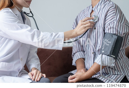 The female doctor measured blood pressure, the patient examined the heartbeat and sat down to talk about health care closely. health care concept 119474870