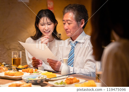 A man drinking with a young woman A man drinking with a young woman 119475096