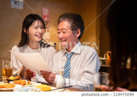 A man drinking with a young woman A man drinking with a young woman 119475099