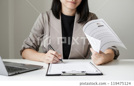 Business woman employer holding resume hiring recruit looking cv resume to hire candidates, analyzing information before job interview. Recruitment concepts 119475124