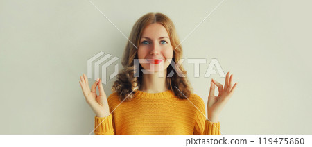 Calm relaxed healthy young woman meditates, girl practicing doing yoga exercises, stress relief 119475860