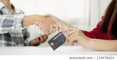 E-commerce Concept. Happy couple holding credit card enjoying doing online shopping and using laptop to enter their card number in-app to purchase and payment in the internet store 119476824