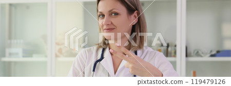 Positive doctor shows two finger V gesture looking in camera 119479126