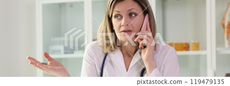 Doctor talks to patient on phone listening to complaints 119479135
